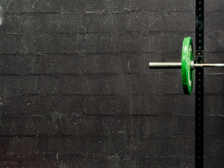 Green barbells on black background - sport concept