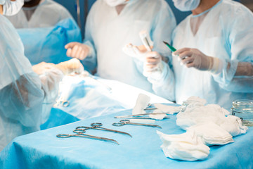 An international team of doctors performs a complex surgical operation on a patient under...
