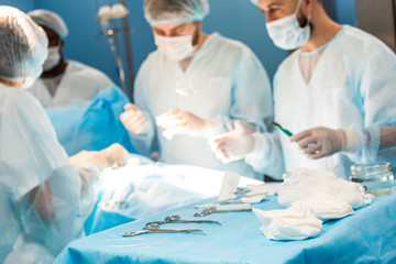 An international team of doctors performs a complex surgical operation on a patient under...