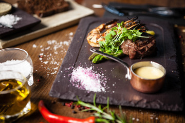 Tasting menu. Beef steak and grilled tiger prawns.