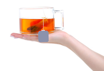 glglass cup mug of tea with teabag in hand on white background isolation