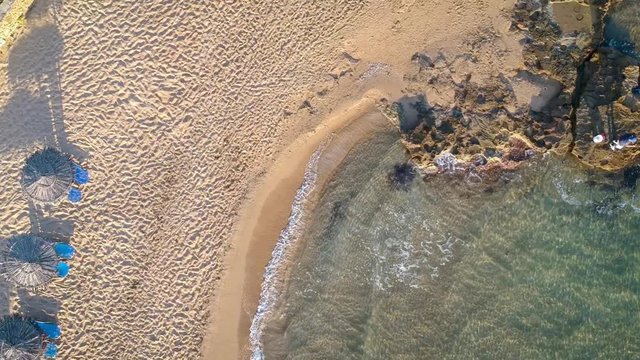 Top shot of coastline in Zakynthos with umbrella patios at sunrise