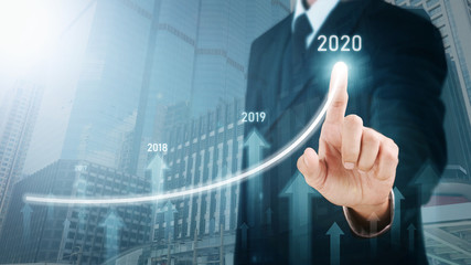 Man standing and pointing hand with Arrow and Line Visual Graphic on Light of Len flare and Boke blue background with Urban view. COPY SPACE. Business Concept : Market Uptrend and Forecast 2020