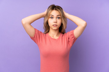 Fototapeta na wymiar Teenager Russian girl isolated on purple background frustrated and takes hands on head