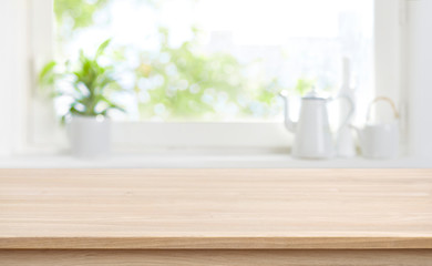 Wooden kitchen table with background of window for product display - obrazy, fototapety, plakaty