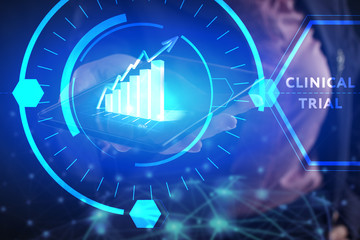 Business, Technology, Internet and network concept. Young businessman working on a virtual screen of the future and sees the inscription: Clinical trial