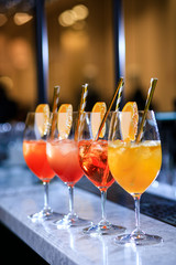 Four glasses of spritz aperitif aperol cocktail with orange slices and ice cubes