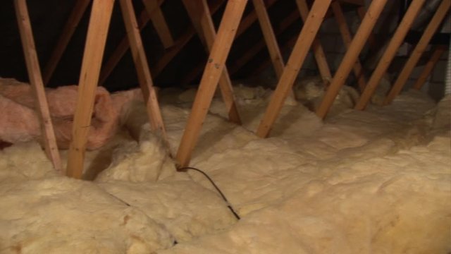 Soft rockwool type insulation in the roof / Attic / Loft of a house or home - Stock Video Clip Footage