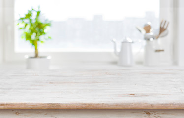 Aged kitchen table top over window background with copy space