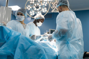 The senior surgeon in the operating room, where the patient is waiting for him, and he begins the...