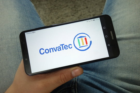 KONSKIE, POLAND - April 13, 2019: Man holding smartphone with ConvaTec logo