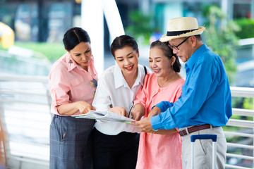 Travel and tourism concept.Group of senior people traveling in the city and looking the map in hand for Shopping Mall Search