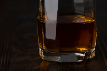 whiskey glass on a wooden table. close up , toned effect