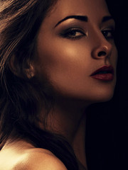 Fototapeta premium Beautiful makeup calm woman with long hair looking sexy with red lipstick on black background. Closeup portrait. Art.Expression portrait.