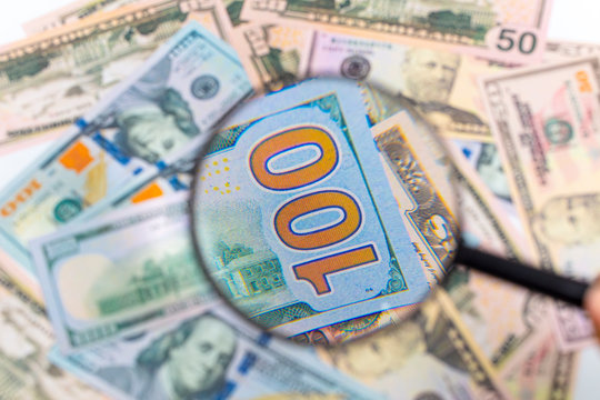 new series one hundred dollars with blue stripes. Detail image with magnifier