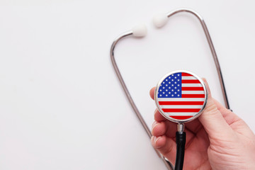 USA healthcare concept. Doctor holding a medical stethoscope.