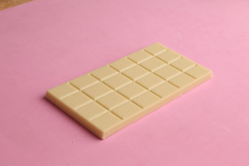 white chocolate tablet in color background