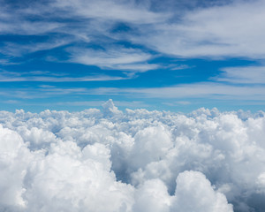 Photo from the window of an airplane. View from above on clouds and the earth. High. Sunny and cloudy day. Photo with telephone. View of the sky.