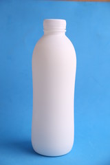 liquid yogurt bottle in color background