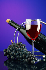 Glass and bottle of wine on the bright multicolored background