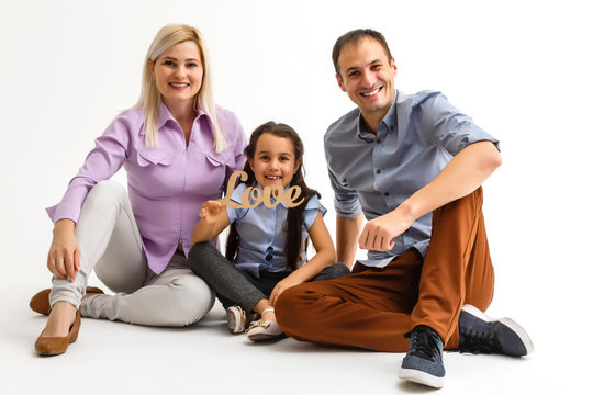 Close up photo of cheerful lovely three people isolated over white background.