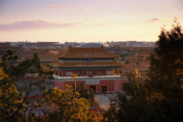 View of the Forbidden City, Beijing, China from above with beautiful sky during sunset and beautiful warm evening light. This shot was taken at Jingshan park which is centre point of Beijing.