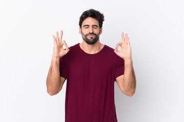 Fototapeta premium Young handsome man with beard over isolated white background in zen pose