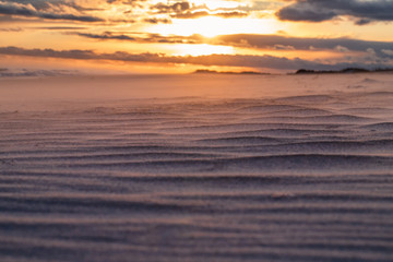 Fototapeta na wymiar Beach Sand Close Up with Sunset Landscape