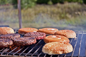 cooking burgers in nature on fire