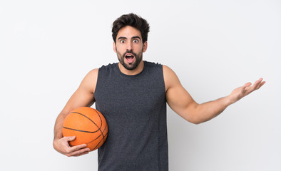 Obraz premium Basketball player man with beard over isolated white background with shocked facial expression