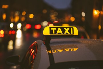Taxi sign on car during night