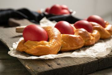 Tasty easter bread. East.Close-uper bread and red eggs. Italian easter bread