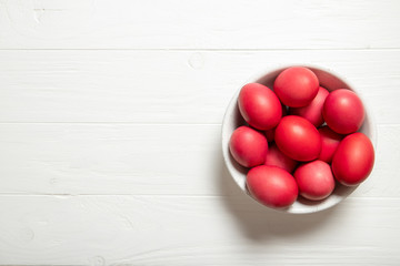 Red easter eggs in a plate. Beautiful easter eggs. Red easter eggs. Place for text