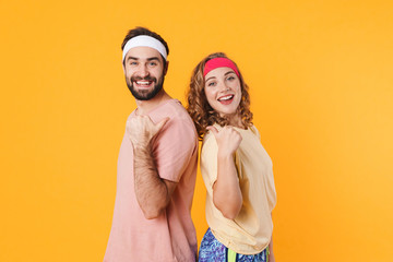 Portrait of athletic couple smiling and pointing fingers at each other