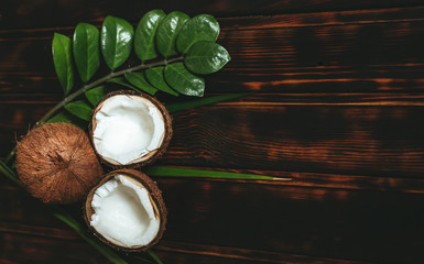 Natural cosmetics with coconut on old wooden background