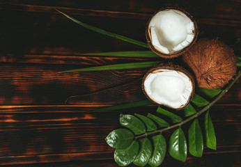 Natural cosmetics with coconut on old wooden background