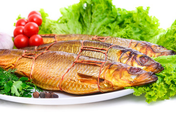 Smoked fish on plate close up