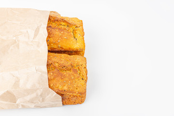 Two loaves of whole-grain bread in eco bag on white background. Freshly baked homemade square bread. Organic and vegetarian food concept. Copy space for text