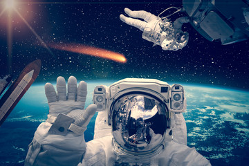 Different spaceships above the earth. Austronauts in outer space. The elements of this image...