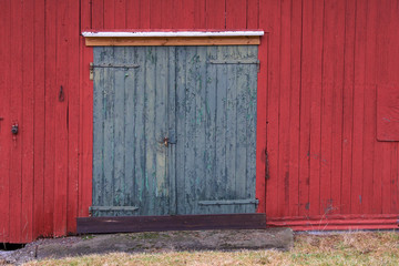 green barn door on red wooden wall