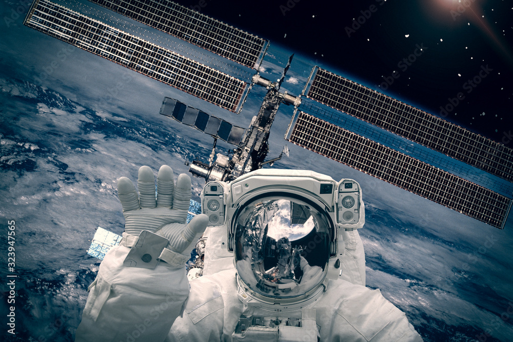 Canvas Prints astronaut and space station against earth. the elements of this image furnished by nasa.