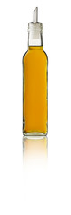 Pineapple Syrup bottle on white background with reflection.