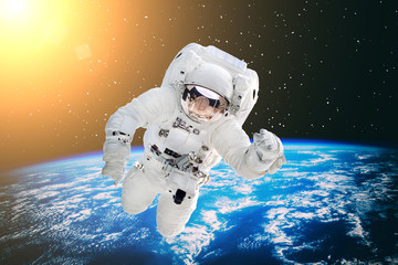 Astronaut and the earth. The elements of this image furnished by NASA.
