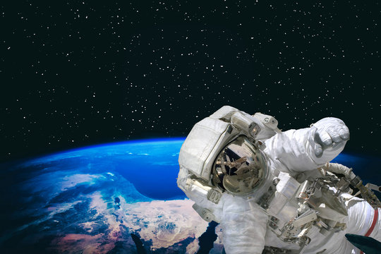 Astronaut and the earth. The elements of this image furnished by NASA.