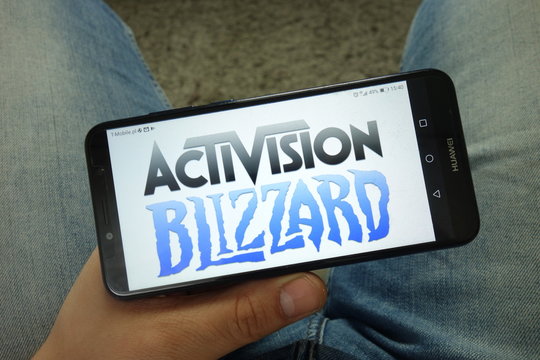 KONSKIE, POLAND - April 13, 2019: Man holding smartphone with Activision Blizzard, Inc. logo