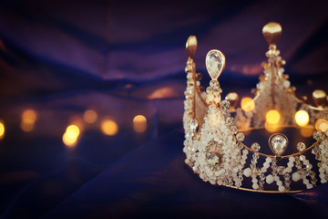 Vintage crown over dark royal purple delicate silk. fantasy medieval period © tomertu