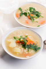 Barley soup, pearl barley in white bowl