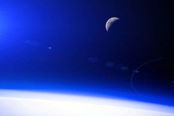 Fototapeta na wymiar Orbital dawn from the space station. Moon. Blue glow. Elements of this image furnished by NASA.