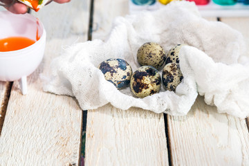 Quail eggs on white wooden background. Industrial quail eggs production