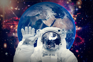 Astronaut and the earth. The elements of this image furnished by NASA.